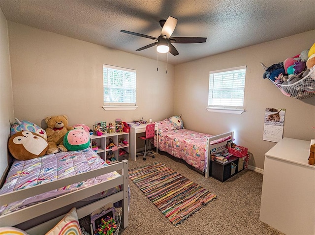 carpeted bedroom featuring multiple windows, ceiling fan, and a textured ceiling