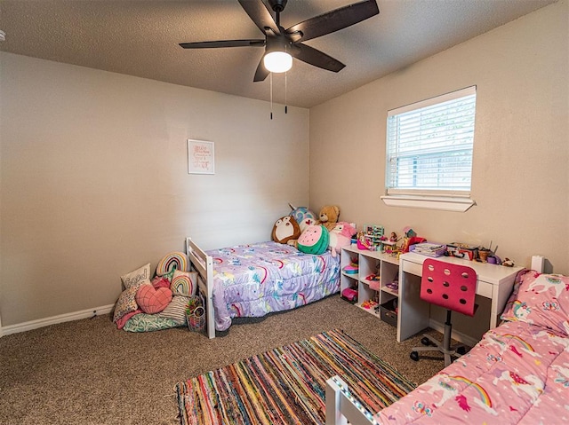 bedroom with ceiling fan, carpet flooring, and a textured ceiling