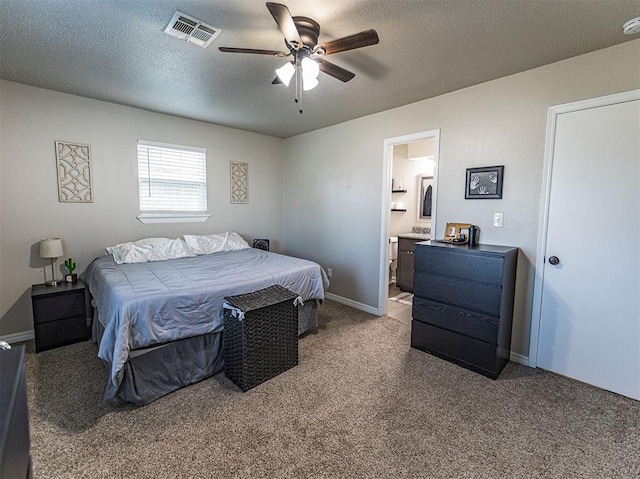 carpeted bedroom featuring ceiling fan, connected bathroom, and a textured ceiling