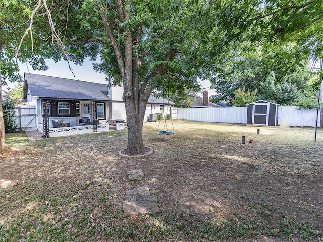 view of yard with a shed and a patio area