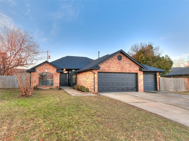 ranch-style home with a garage and a front yard