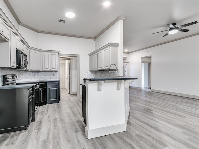 kitchen with ornamental molding, a breakfast bar area, gray cabinetry, and electric stove