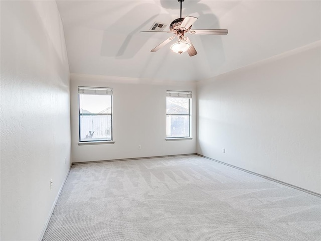 carpeted spare room featuring ceiling fan