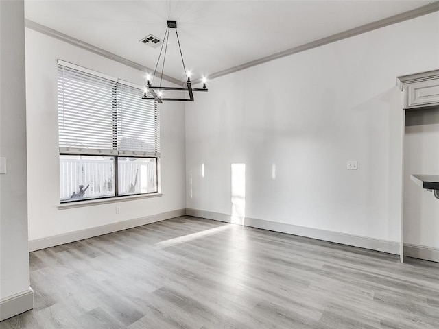 unfurnished dining area with a notable chandelier, crown molding, and light hardwood / wood-style flooring