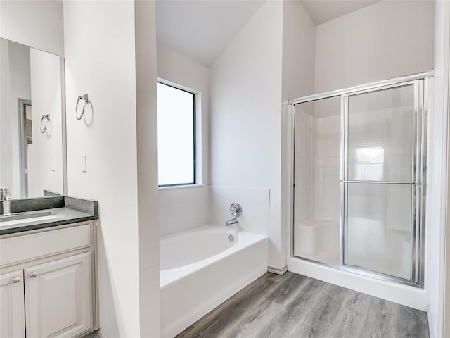 bathroom featuring vanity, wood-type flooring, and shower with separate bathtub