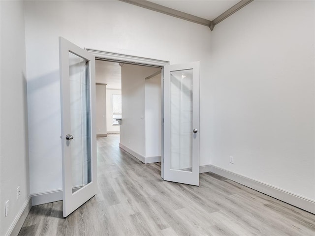 unfurnished bedroom with ornamental molding and light wood-type flooring