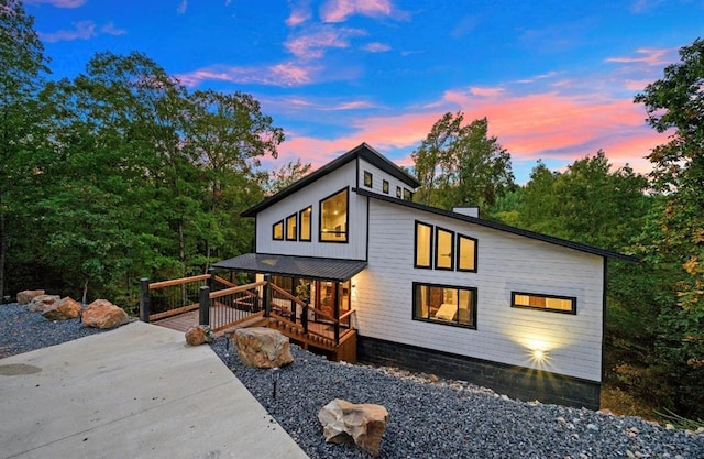 view of back house at dusk