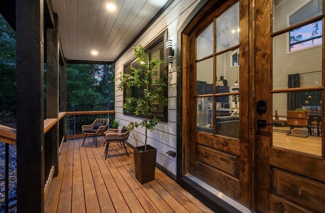 deck at dusk with covered porch