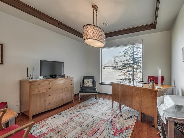 office area with ornamental molding and light hardwood / wood-style floors