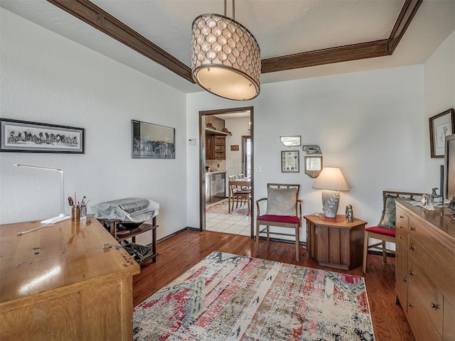 living area featuring ornamental molding and light hardwood / wood-style floors