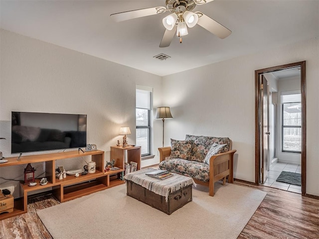 living room with hardwood / wood-style flooring and ceiling fan