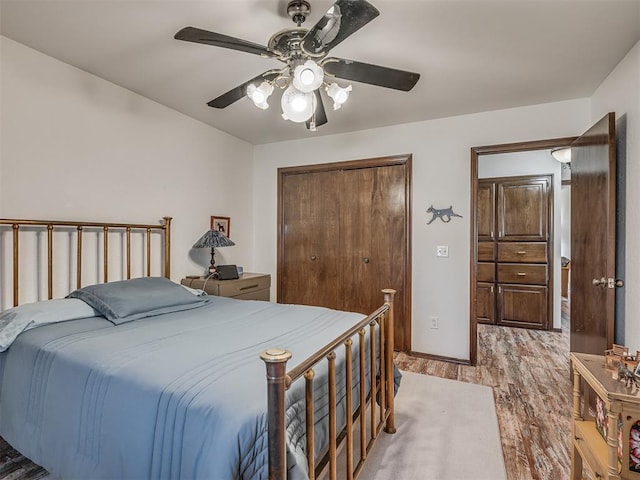 bedroom with light hardwood / wood-style flooring, a closet, and ceiling fan