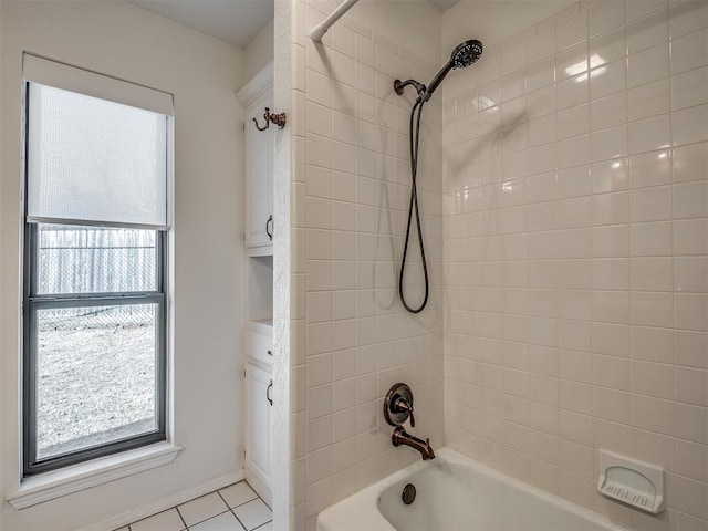 bathroom with tile patterned floors and tiled shower / bath combo