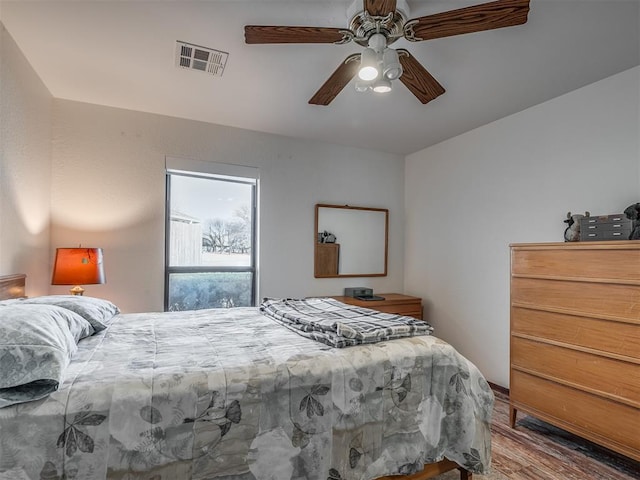 bedroom with wood-type flooring and ceiling fan