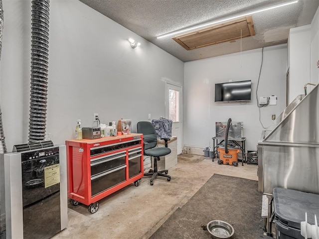 miscellaneous room featuring concrete flooring and a textured ceiling