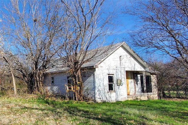 view of home's exterior with a yard