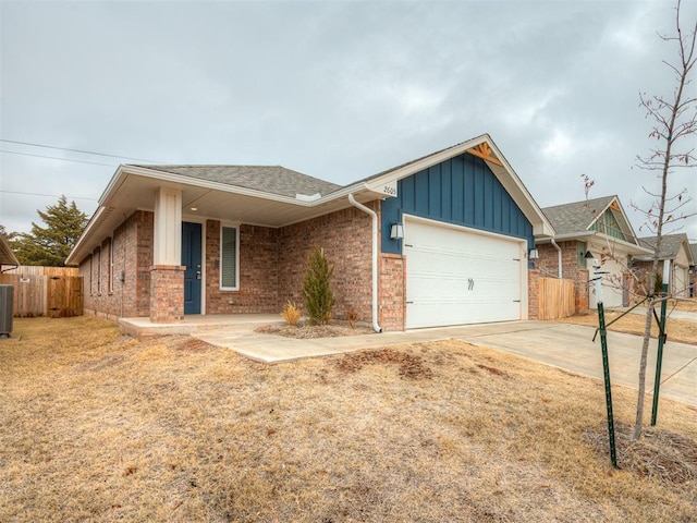 view of front of home with a garage and central air condition unit