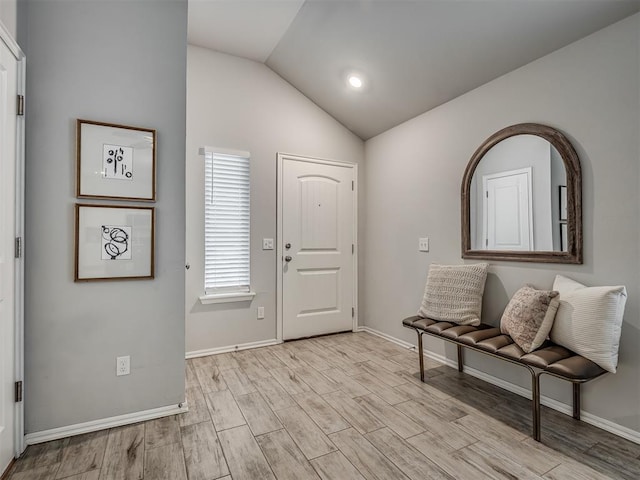 foyer with lofted ceiling and light hardwood / wood-style flooring