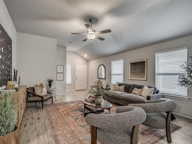 living room with vaulted ceiling, light hardwood / wood-style floors, and ceiling fan