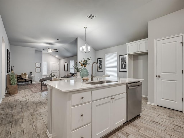 kitchen featuring pendant lighting, sink, a kitchen island with sink, white cabinets, and stainless steel dishwasher