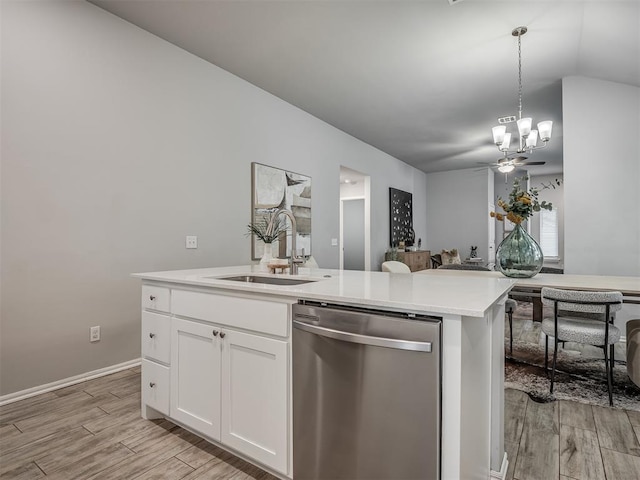 kitchen featuring ceiling fan with notable chandelier, decorative light fixtures, white cabinetry, dishwasher, and sink