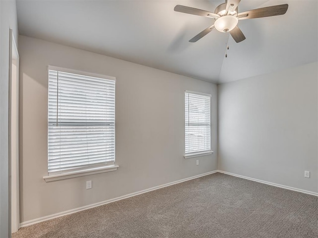 spare room with ceiling fan, lofted ceiling, and carpet floors