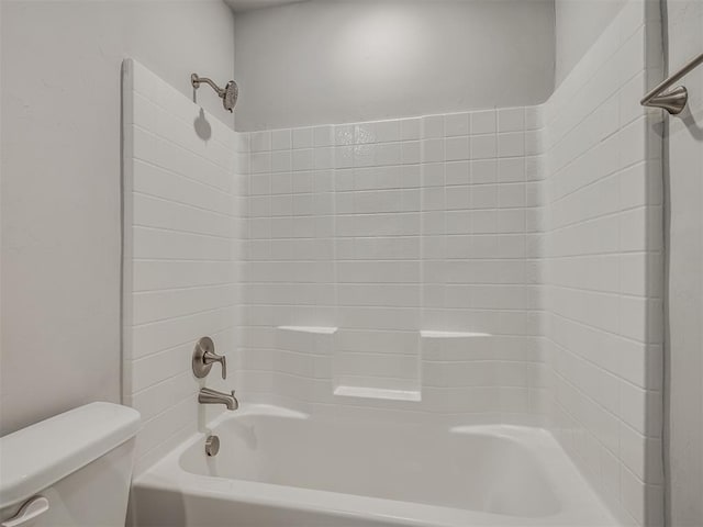 bathroom with bathtub / shower combination and toilet