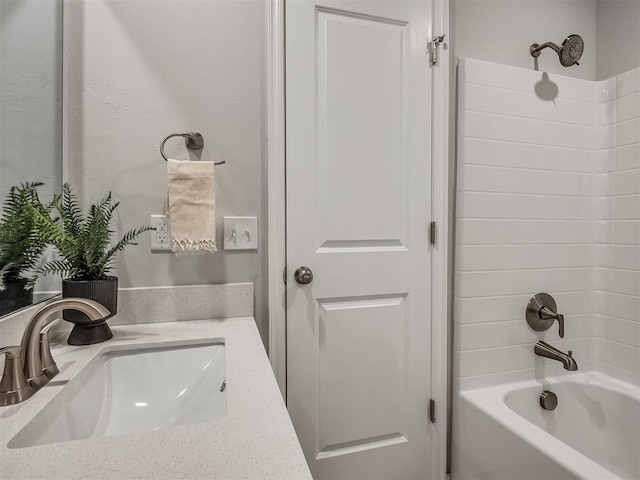 bathroom featuring washtub / shower combination and vanity