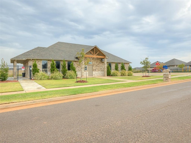 view of front of house with a front lawn and a playground