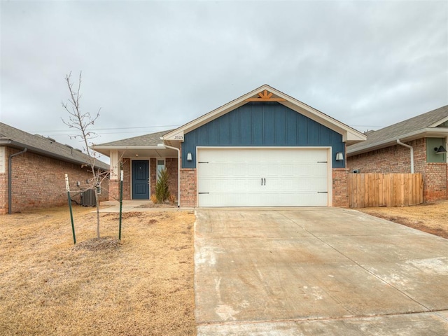 ranch-style home with central AC and a garage