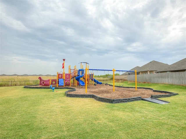 view of playground with a lawn