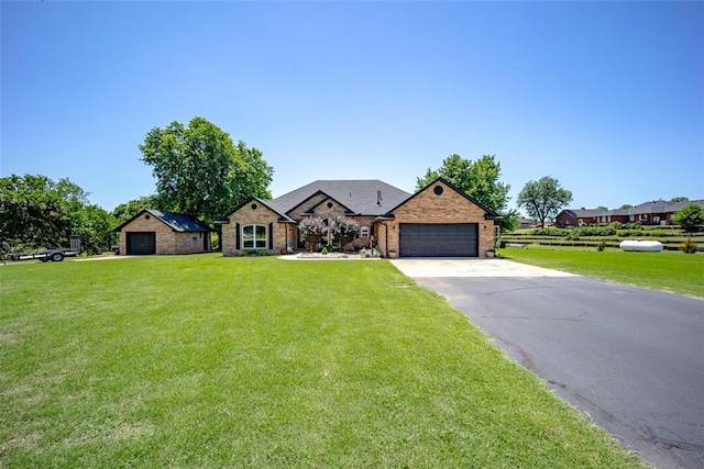 single story home featuring a garage and a front lawn