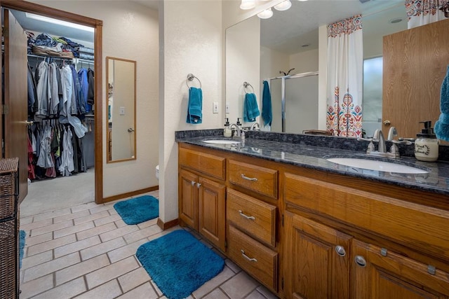 bathroom featuring vanity and an enclosed shower