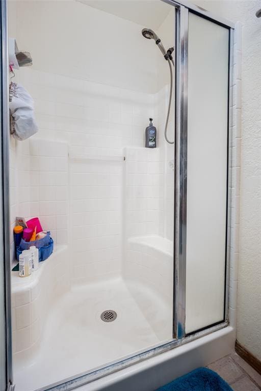 bathroom with a shower with door