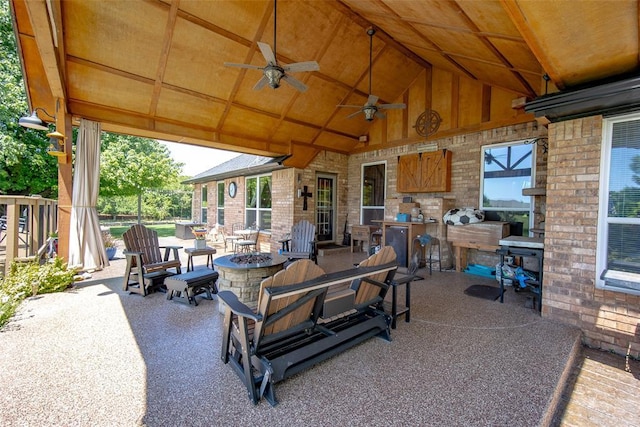 view of patio / terrace with ceiling fan and an outdoor fire pit