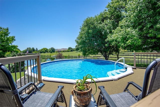 view of pool with a water view