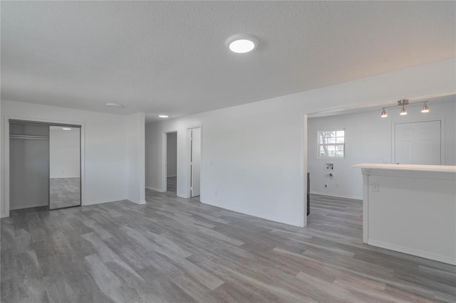 spare room with hardwood / wood-style flooring and a textured ceiling