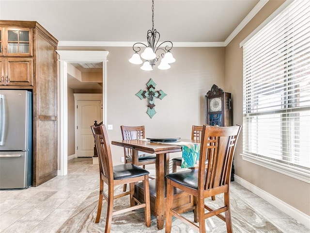 dining room with an inviting chandelier and ornamental molding