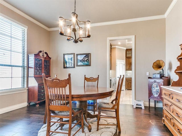 dining area with a notable chandelier, ornamental molding, dark hardwood / wood-style flooring, and a wealth of natural light