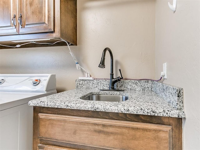 laundry room featuring cabinets, washer / dryer, and sink