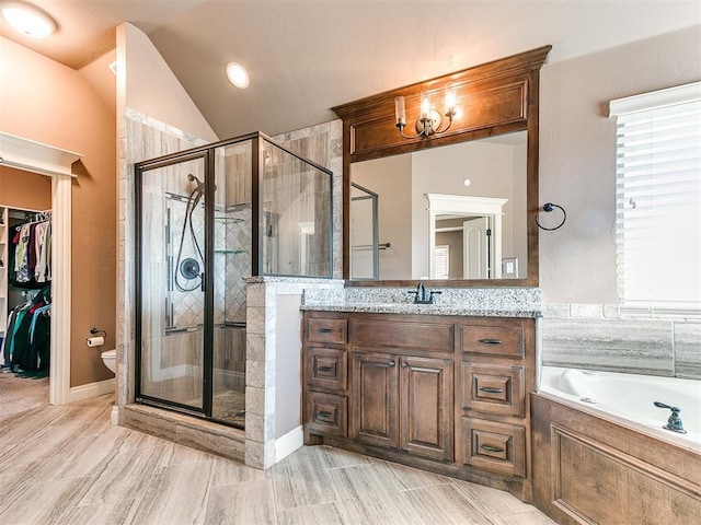 bathroom featuring vanity, separate shower and tub, and lofted ceiling