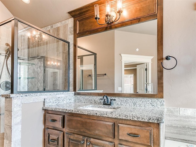 bathroom featuring vanity and a shower with shower door