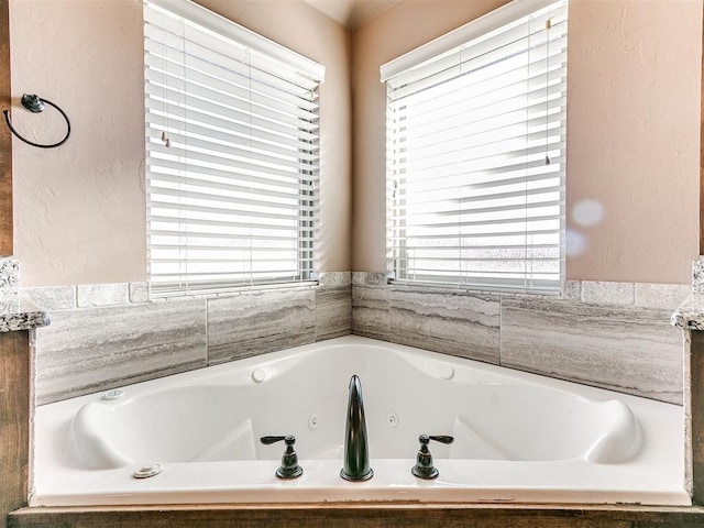 bathroom with a relaxing tiled tub