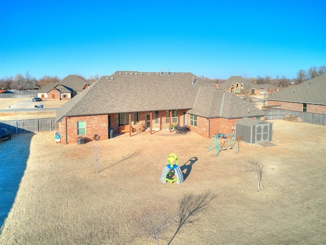 rear view of house with a playground