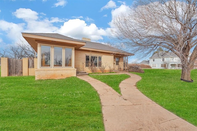 rear view of property with a yard