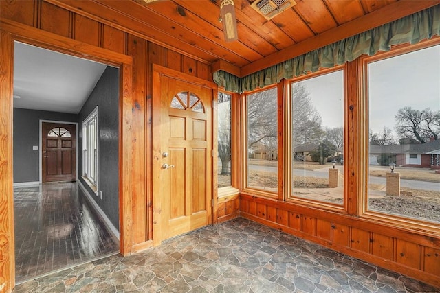 unfurnished sunroom featuring wood ceiling