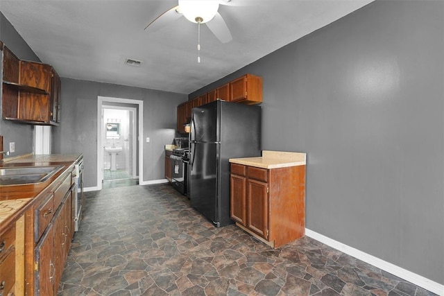 kitchen featuring black fridge, ceiling fan, dishwasher, and sink