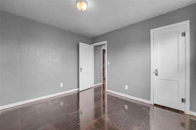 empty room with dark wood-type flooring