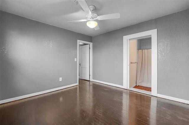 unfurnished bedroom featuring dark wood-type flooring and ceiling fan