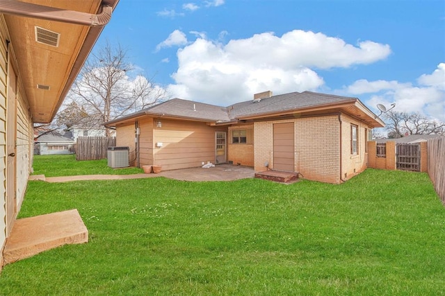 back of property featuring cooling unit, a patio area, and a lawn